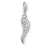 Silver wing-shaped pendant with embedded stones on a white background
