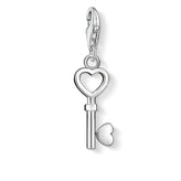 Silver key-shaped charm with a heart design on a white background