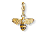 Gold bee charm with black and clear gemstones on a white background