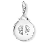Silver pendant with baby footprints on a white background