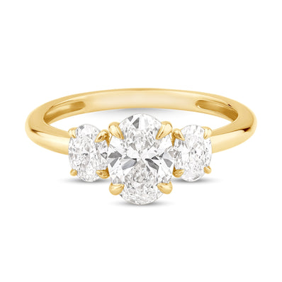 Yellow gold ring, featuring 3 Oval Lab grown diamonds. One large lab grown diamond in the center and two smaller lab grown diamonds at either side. 