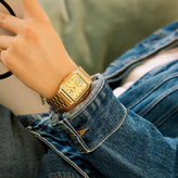 Gold wristwatch on a person's wrist
