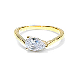 A yellow gold ring featuring a marquise-cut clear gemstone in a prong setting, shown on a clean white background.