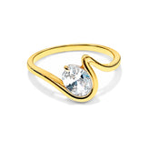 A yellow gold ring with a curved, wave-like band and a large, clear pear-cut gemstone in a prong setting, shown on a clean white background.