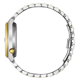 Close-up of a watch with a gold and silver band on a white background