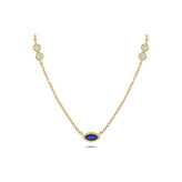 A delicate yellow gold chain necklace featuring a central marquise-cut blue sapphire pendant and matching gold link charms on each end, each accented with a small round clear stone, shown on a plain white background.
