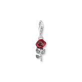 Silver charm with a red rose design on a white background