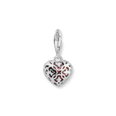 Silver heart-shaped charm with intricate back design on a white background