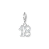 Silver charm with the number 18 on a white background