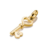 Gold key-shaped pendant with a heart on a white background