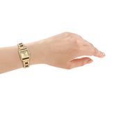 a hand in a gold lady watch 
