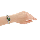A hand in a DKNY Mini Watch with Green Dial and Two Tone Bracelet 21mm x 27mm DK1L143M0065