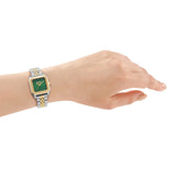 a hand in a DKNY Signature Shape Women's Watch – Green Dial & Two-Tone Stainless Steel Bracelet