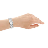 Hand wearing a silver watch on a white background