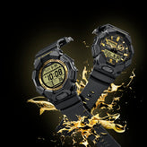 Two rugged black digital and analog wristwatches with gold accents, shown floating above a dramatic gold splash on a black background.
