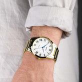 A man wears a Sekonda Analogue Watch with White Dial and Gold Tone Bracelet 40mm SK30247