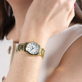 A woman wears a Sekonda Analogue Watch with White Dial and Gold Tone Bracelet 28mm SK40681